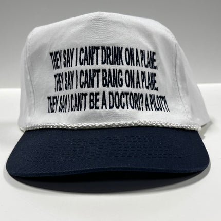 They say I can’t drink on a plane they say I can’t bang on a plane on a white crown navy brim SnapBack hat cap custom embroidered