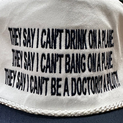 They say I can’t drink on a plane they say I can’t bang on a plane on a white crown navy brim SnapBack hat cap custom embroidered